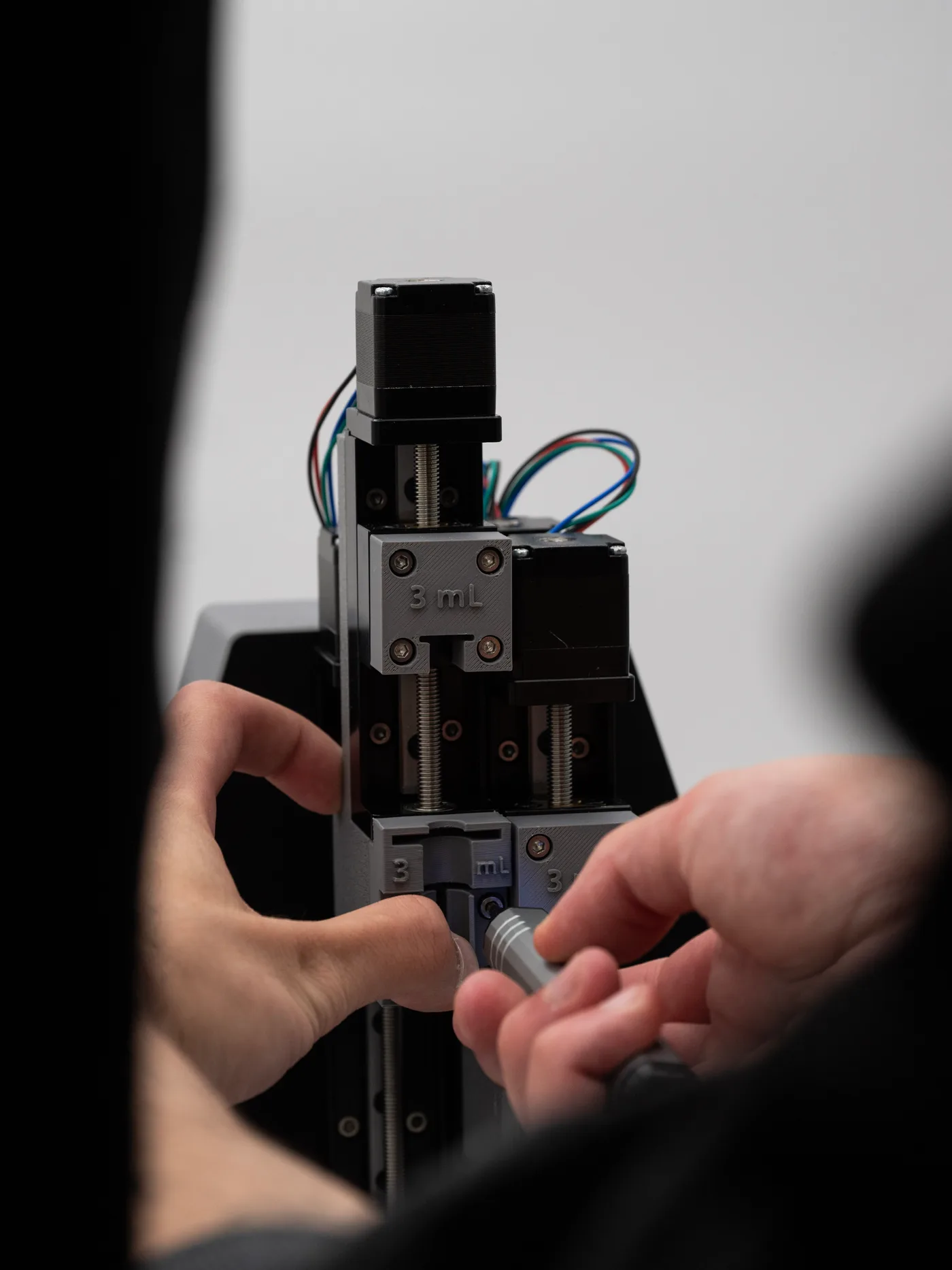 Hands loading a syringe into the Printessa One gel printer